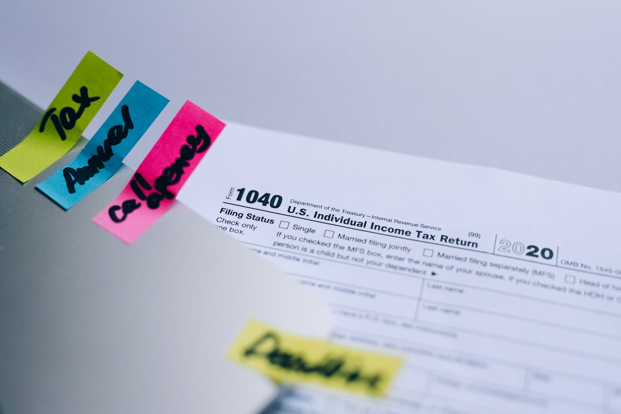 Close-up of 1040 U.S. tax form with colorful sticky notes for organization.